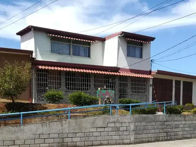 a building with a sign in front of it at Belis in Alajuela City