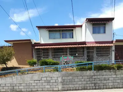 a house with a sign in front of it at Belis in Alajuela City