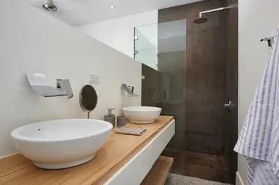 a bathroom with a large white sink and a shower at Villa Ethir in Tamarindo