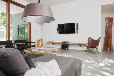 a living room with a couch and a tv at Villa Ethir in Tamarindo