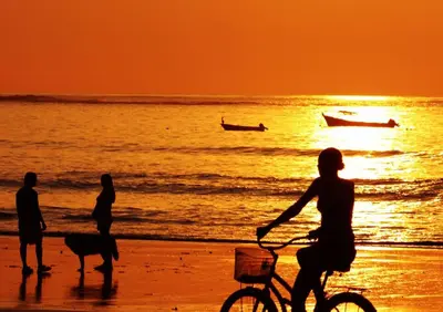 a group of people on the beach at sunset at Villa Ethir in Tamarindo