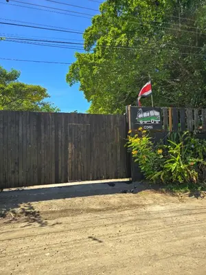 a fence with a flag on top of it at Hospedaje Combi dream bird in Guanacaste