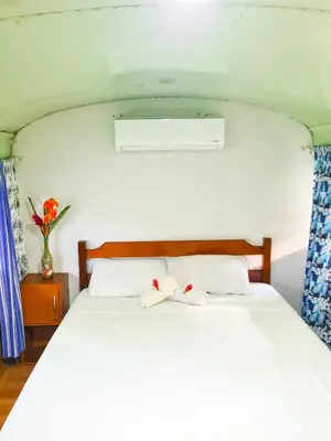 a bedroom with a bed with two towels on it at Hospedaje Combi dream bird in Guanacaste