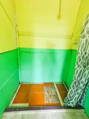 a corner of a room with green and yellow walls at Hospedaje Combi dream bird in Guanacaste