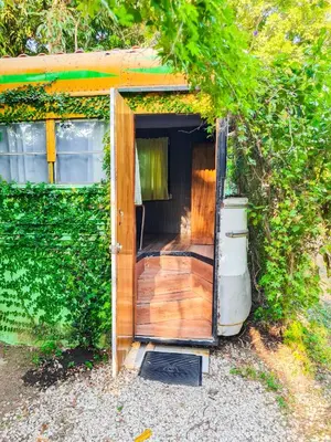 an open door of a trailer with a porch at Hospedaje Combi dream bird in Guanacaste