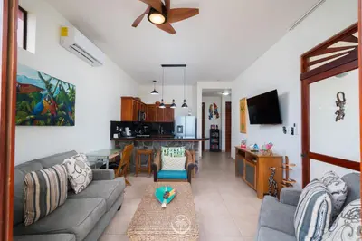 a living room with a couch and a table at Bahia Azul 2A beachfront, Jaco Beach, 1st floor in Jacó