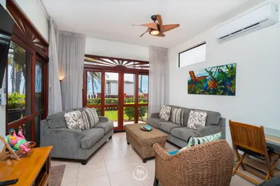 a living room with two couches and a table at Bahia Azul 2A beachfront, Jaco Beach, 1st floor in Jacó