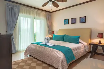 a bedroom with a bed and a ceiling fan at Diamante del Sol Ocean front condos, Micasas in Jacó