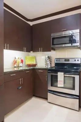 a kitchen with a stove and a microwave at Diamante del Sol Ocean front condos, Micasas in Jacó