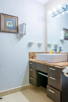 a bathroom with a sink and a mirror at Diamante del Sol Ocean front condos, Micasas in Jacó