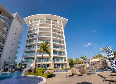 a hotel with a swimming pool and a resort at Diamante del Sol Ocean front condos, Micasas in Jacó