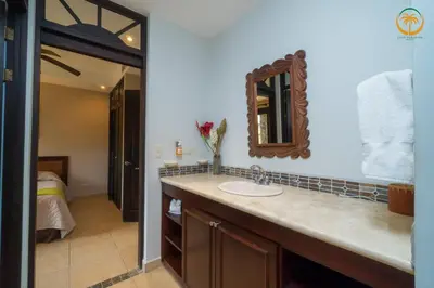 a bathroom with a sink and a mirror at Bahia Encantada beach front proyect, Micasas in Jacó