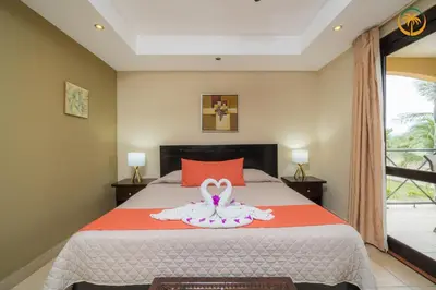 a bedroom with a bed with a towel on it at Bahia Encantada beach front proyect, Micasas in Jacó
