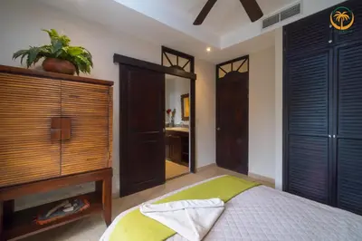 a bedroom with a bed and a dresser and a mirror at Bahia Encantada beach front proyect, Micasas in Jacó