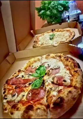 two pizzas in a box with two pizzas at Nature house in Monteverde Costa Rica