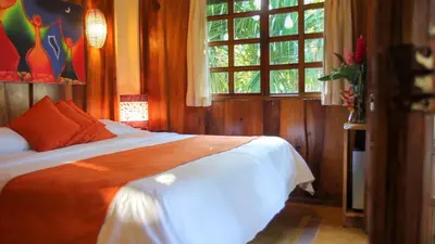 a bedroom with a bed and a window at Hotel Tropico Latino in Santa Teresa Beach