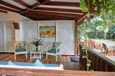 a living room with a table and chairs on a porch at Hotel Tropico Latino in Santa Teresa Beach