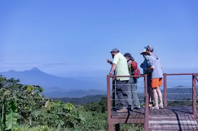 a group of people standing on top of a viewing deck at Villa Blanca Cloud Forest Hotel & Retreat in San Ramón