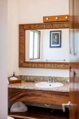 a bathroom with a sink and a mirror at Si Como No Resort & Wildlife Refuge in Manuel Antonio