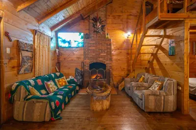 a living room with couches and a fireplace in a log cabin at Cabaña de montaña La Magnolia, Cerro de la Muerte De La Cañuela Cloud Forest in Tres de Junio