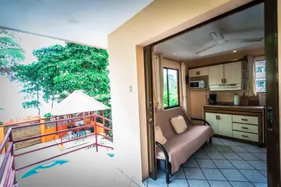 a room with a kitchen and a balcony at La Dolce Vita in Esterillos