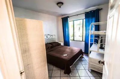 a small bedroom with a bed and a window at La Dolce Vita in Esterillos