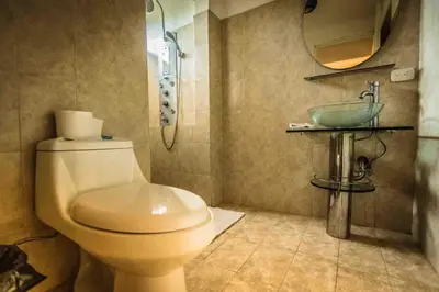 a bathroom with a toilet and a sink at La Dolce Vita in Esterillos