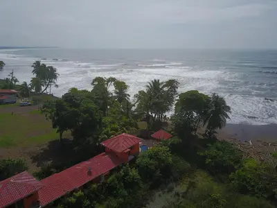 an aerial view of the ocean with houses and trees at La Dolce Vita in Esterillos