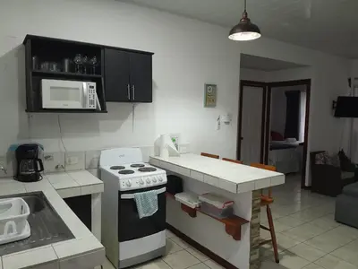 a kitchen with a stove and a counter top at Casa Arenas in Manuel Antonio