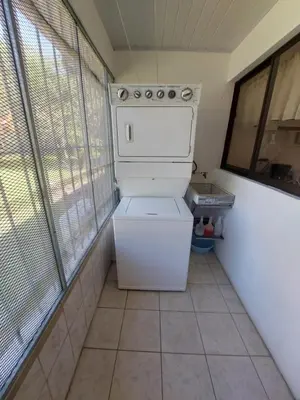 a white washer and dryer in a small room at Casa Arenas in Manuel Antonio