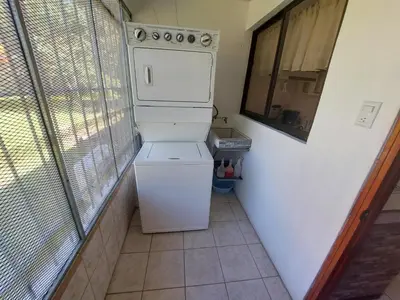 a washer and dryer in a room with a window at Casa Arenas in Manuel Antonio