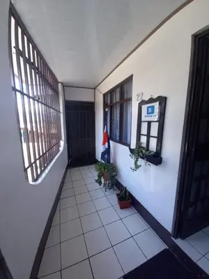 an empty hallway of a building with a flag on the wall at Duerme tranquilo in Alajuela City