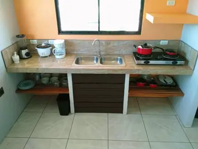 a kitchen counter with a sink and a stove at Casa Monarca - Monteverde in Monteverde Costa Rica