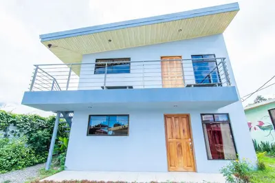a house with a balcony on top of it at Casa Monarca - Monteverde in Monteverde Costa Rica