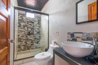 a bathroom with a sink and a toilet and a shower at Casa Monarca - Monteverde in Monteverde Costa Rica
