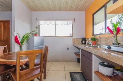 a kitchen with a table and a dining room at Casa Monarca - Monteverde in Monteverde Costa Rica