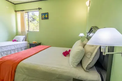 a bedroom with a bed with a lamp and flowers on it at Kayak Lodge in Damas