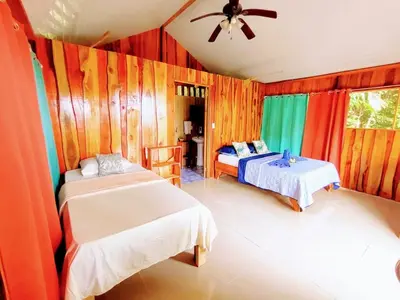a bedroom with two beds and a ceiling fan at The Sunset Tucano Lodge in Drake