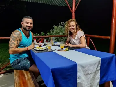 a man and a woman sitting at a table at The Sunset Tucano Lodge in Drake
