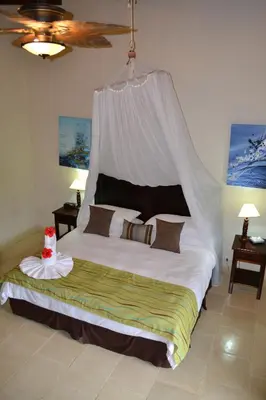 a bedroom with a large bed with a canopy at The Falls at Manuel Antonio in Manuel Antonio