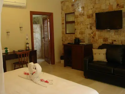 a hotel room with a bed with a swan on it at The Falls at Manuel Antonio in Manuel Antonio