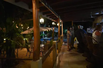 a group of people standing outside of a restaurant at night at The Falls at Manuel Antonio in Manuel Antonio