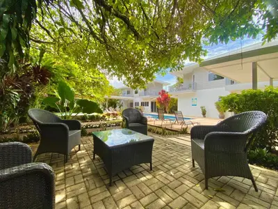 a patio with chairs and a table and a building at Uvita Paradise in Uvita