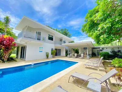 a villa with a swimming pool and a house at Uvita Paradise in Uvita