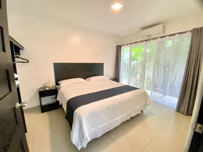 a bedroom with a large bed and a large window at Uvita Paradise in Uvita