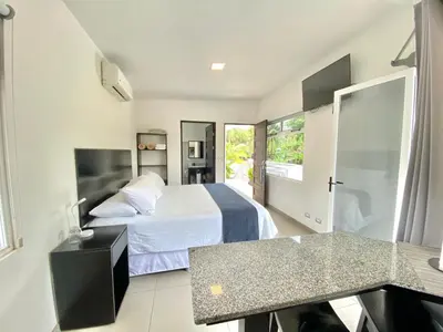 a hotel room with a bed and a desk at Uvita Paradise in Uvita