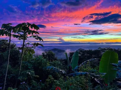 a sunset in the jungle with a view of the sky at Domos Mirador Romantic Private Honeymoon Glamping in Miramar