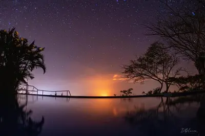a starry night with a view of a body of water at Domos Mirador Romantic Private Honeymoon Glamping in Miramar