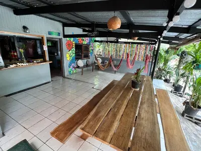 a room with a wooden bench in the middle at Pura Vida Hostel in Montezuma