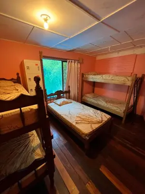 a room with two bunk beds and a window at Pura Vida Hostel in Montezuma